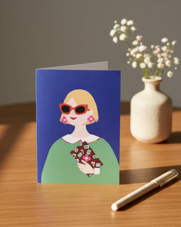 Lucky Tiles greeting card displayed on a tabletop with decorative accessories featuring Mahjong-inspired artwork