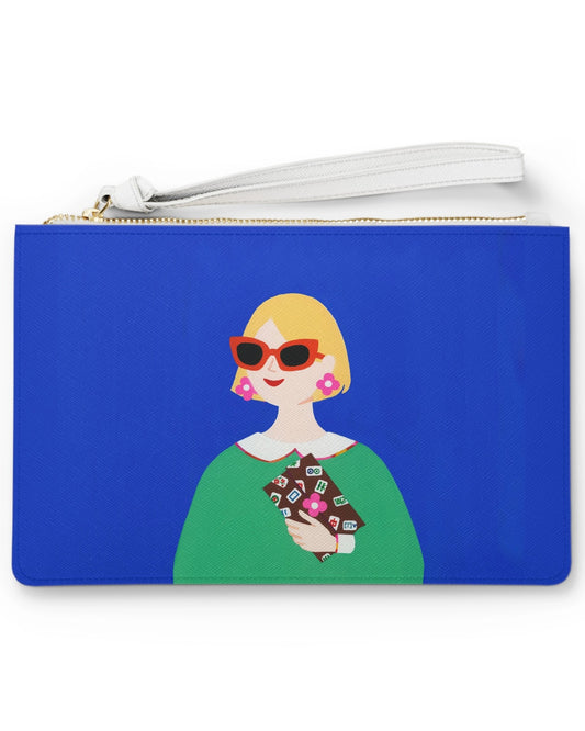 Lucky Tiles clutch bag featuring a stylish modern muse with bold sunglasses and a Mahjong-inspired clutch against a cobalt blue background