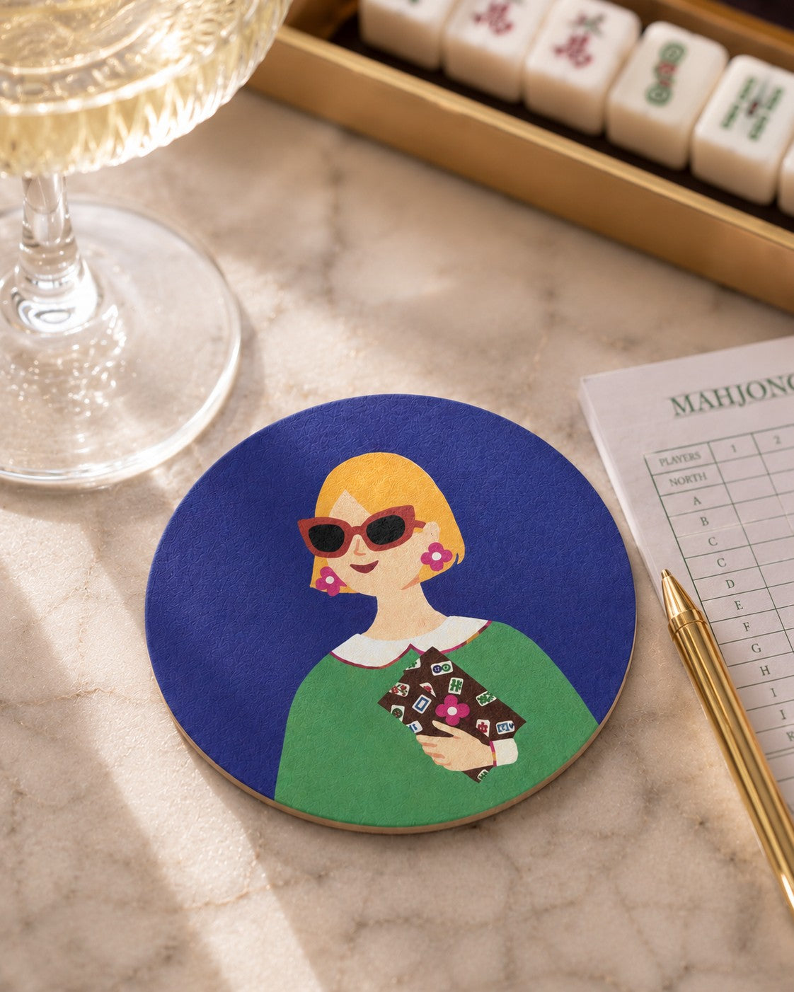 Lucky Tiles Mahjong-inspired coaster beside sparkling water on a bright Mahjong game table