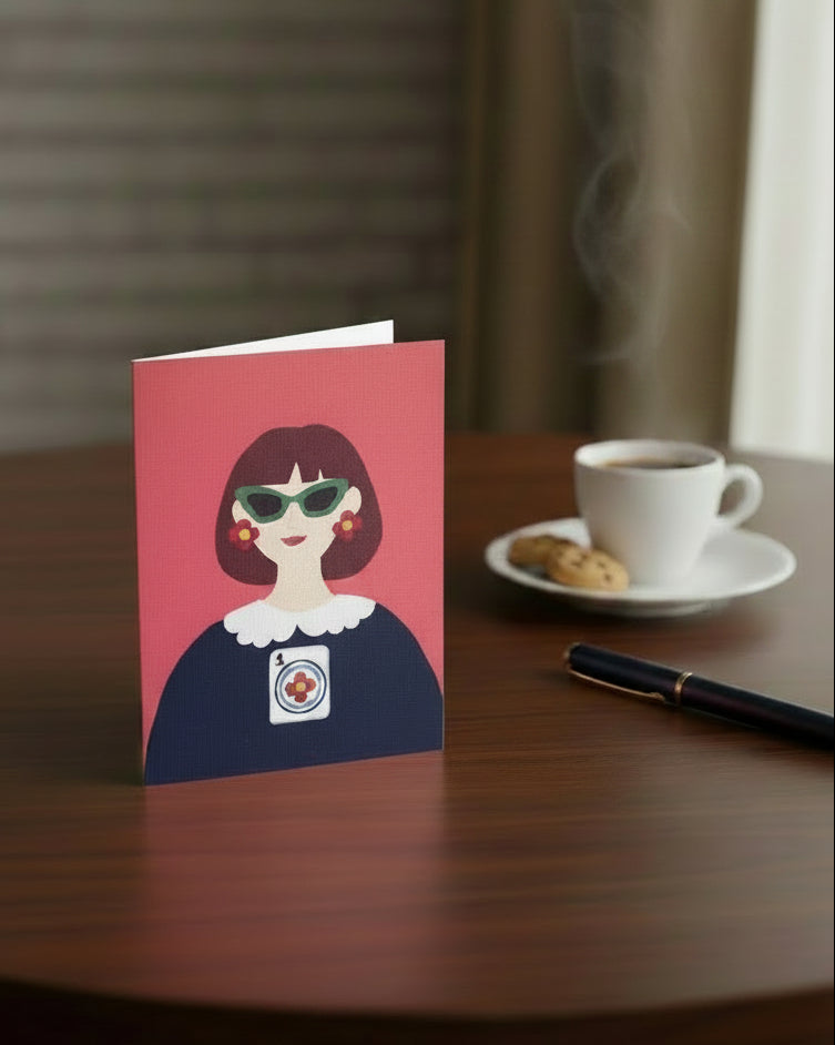 The One and Only Prime Dot greeting card displayed beside a coffee cup on a tabletop
