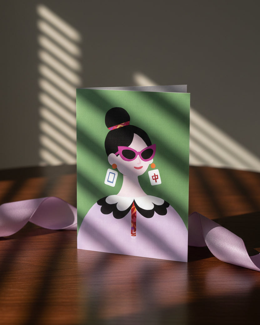 The Dragon Pair greeting card displayed on a tabletop with decorative accessories featuring Mahjong-inspired artwork