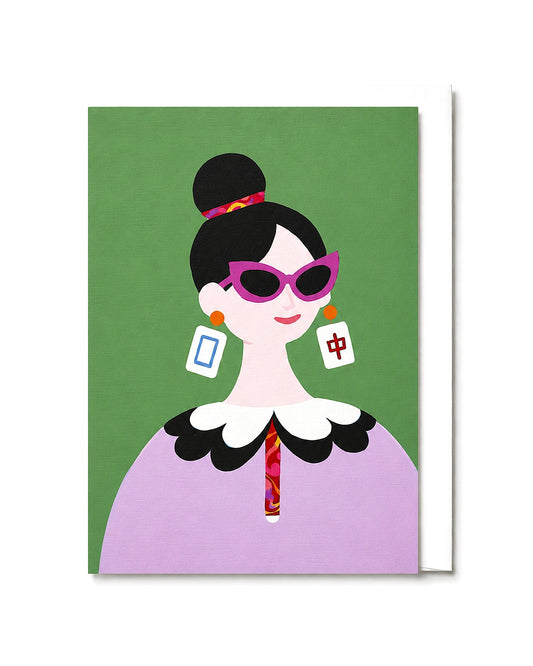 The Dragon Pair greeting card featuring a stylish woman wearing bold sunglasses and Mahjong-inspired dragon tile earrings against a soft green background