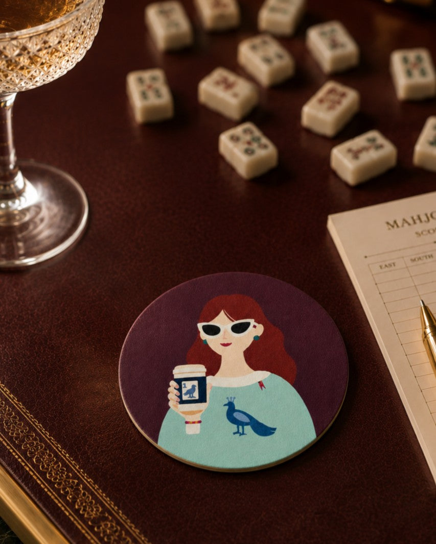 Before the Game Mahjong-inspired coaster on an elegant Mahjong game table with cocktail glass and score card
